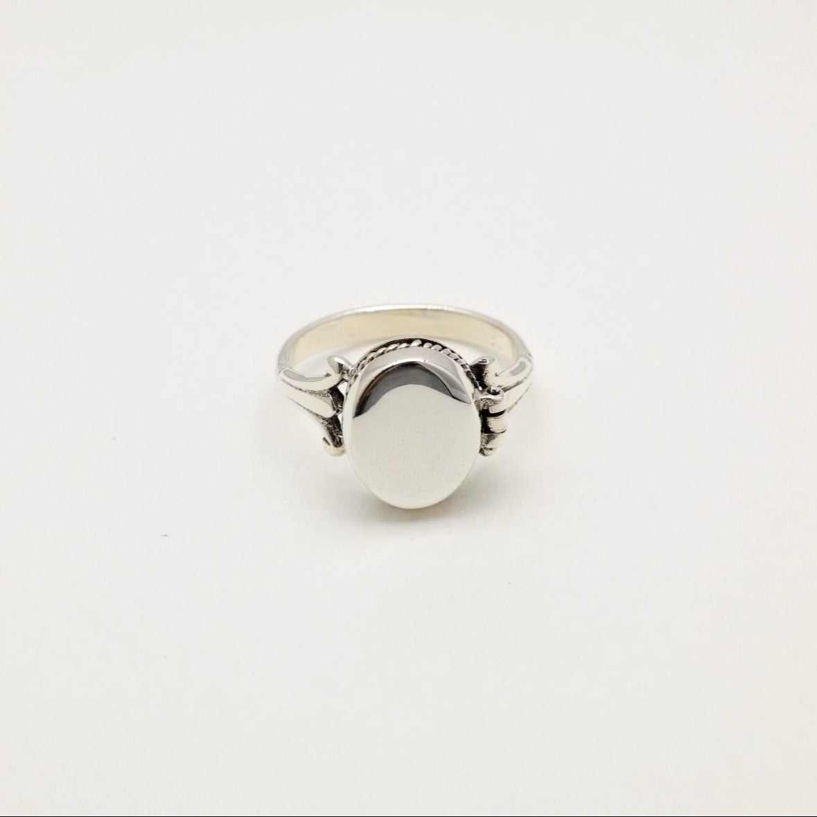Closed Séraphine Locket Ring in sterling silver, photographed on a white background