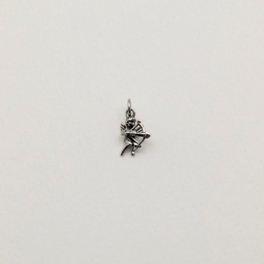 A sterling silver Cupid pendant charm featuring a bow and arrow, photographed on a soft white background.