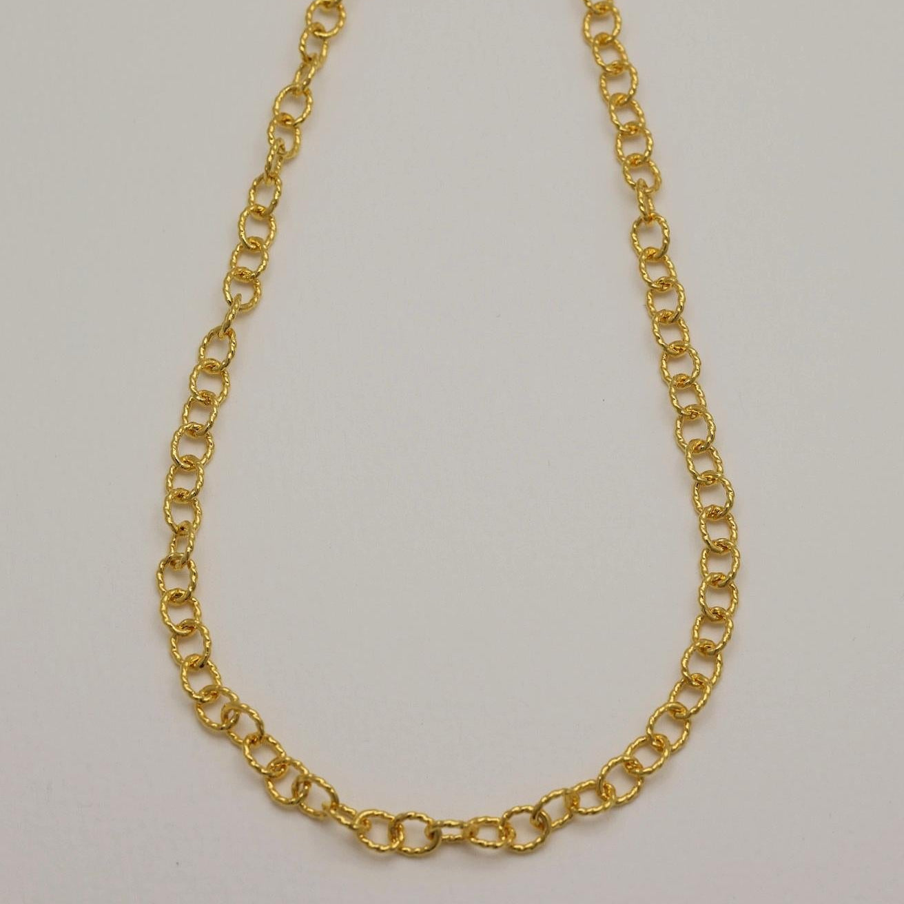 Gold vermeil twisted chain necklace displayed on white background