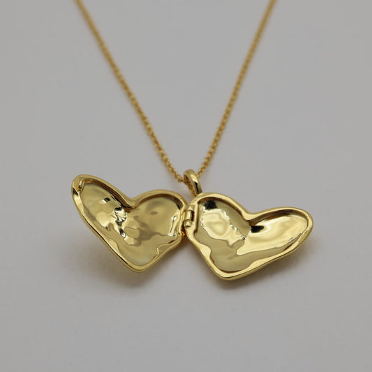 Gold vermeil heart locket necklace with polished finish, photographed open and closed on a plain background.