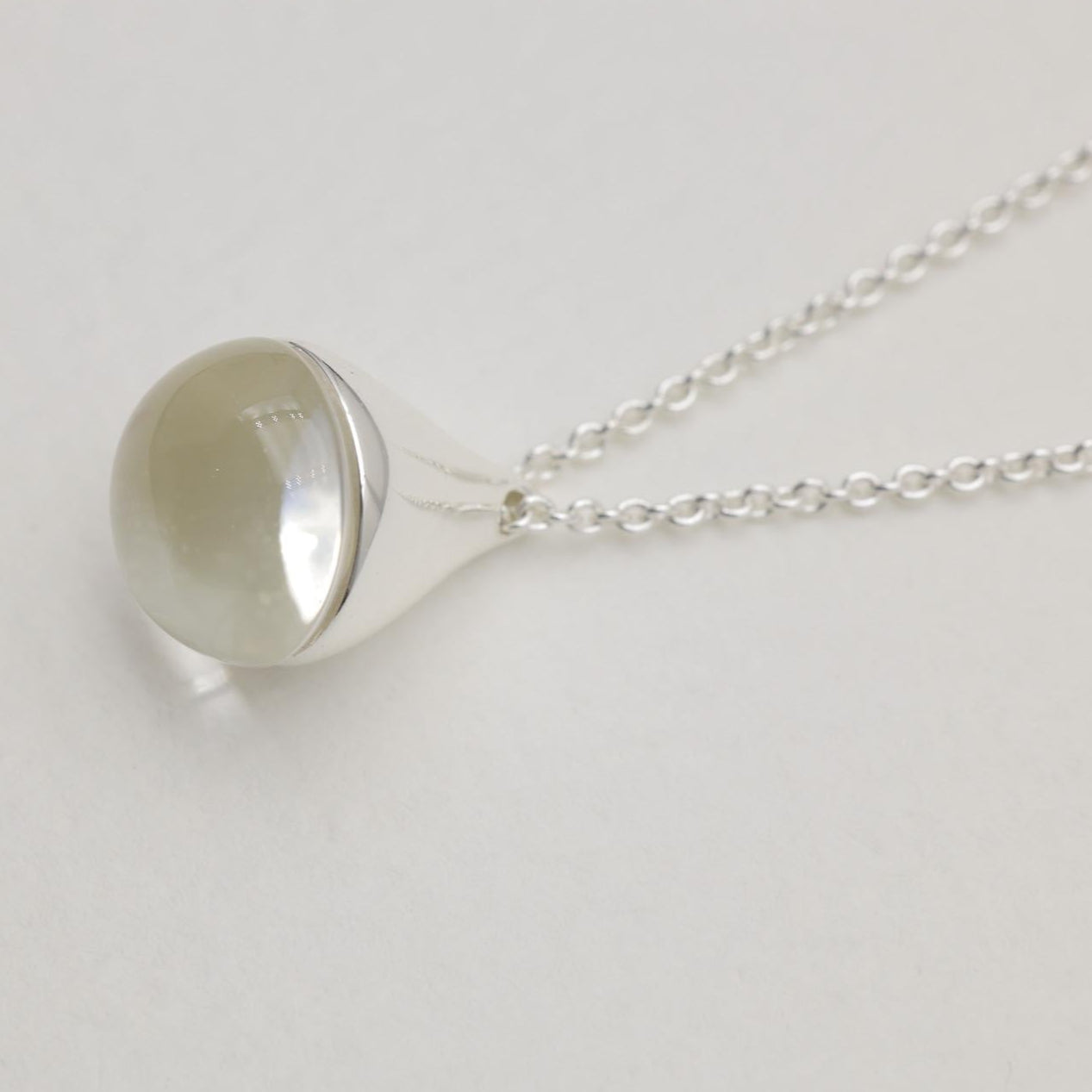 Sterling silver necklace with a smooth round crystal pendant and fine chain, 42cm + 3cm extension.