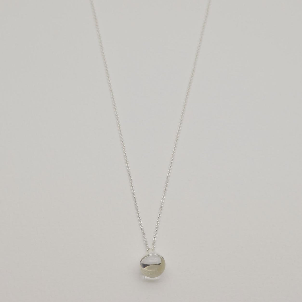 Sterling silver necklace with a smooth round crystal pendant and fine chain, 42cm + 3cm extension.