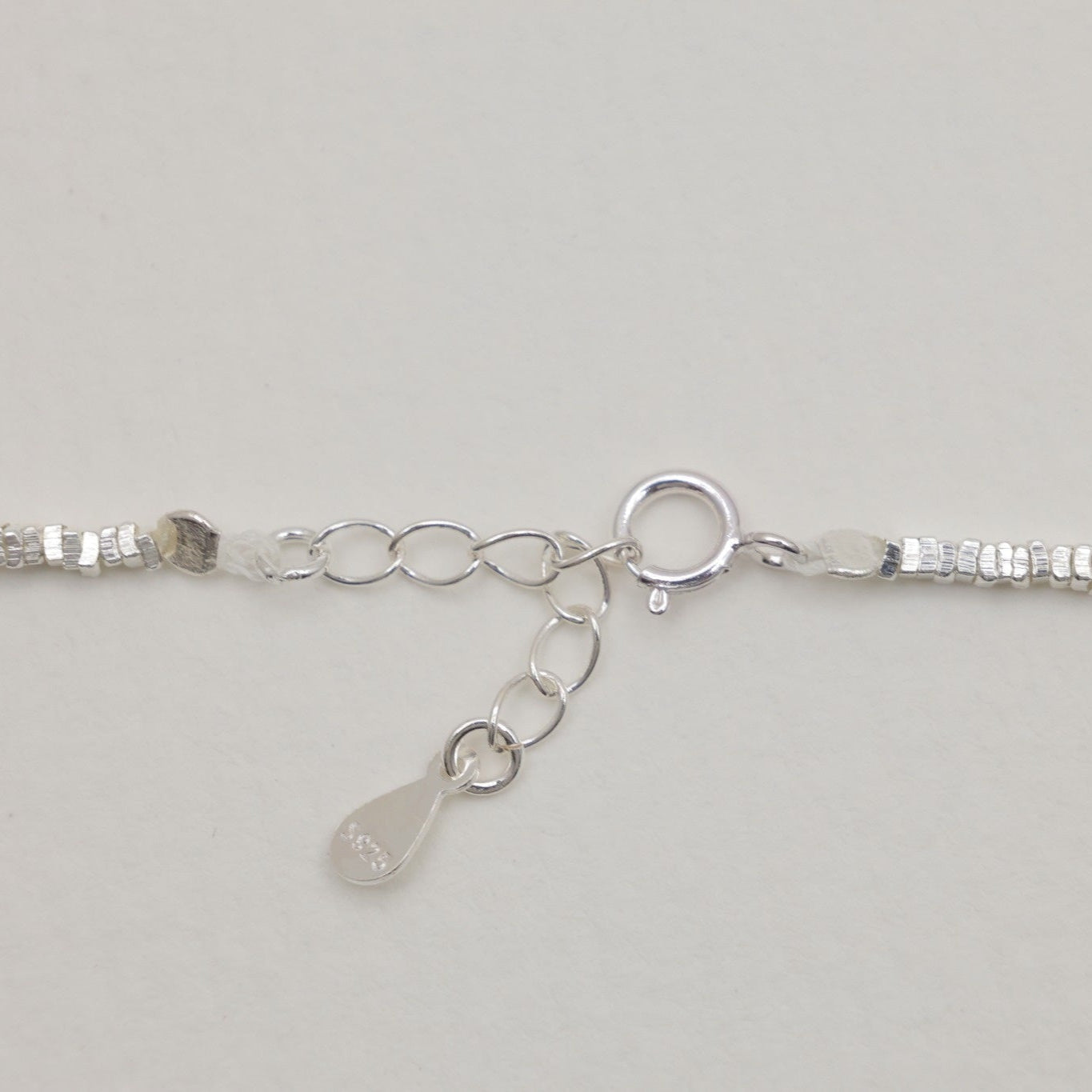 Spring clasp and extension chain of the Victoire Necklace with engraved tag
