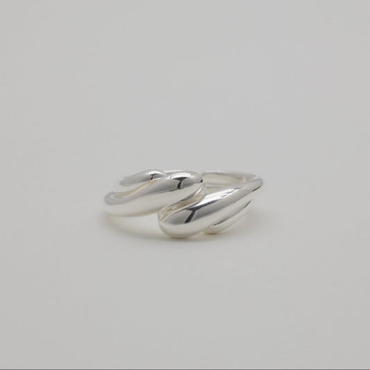 Sterling silver duo rings with soft sculptural curves and open adjustable bands, displayed on a neutral background.