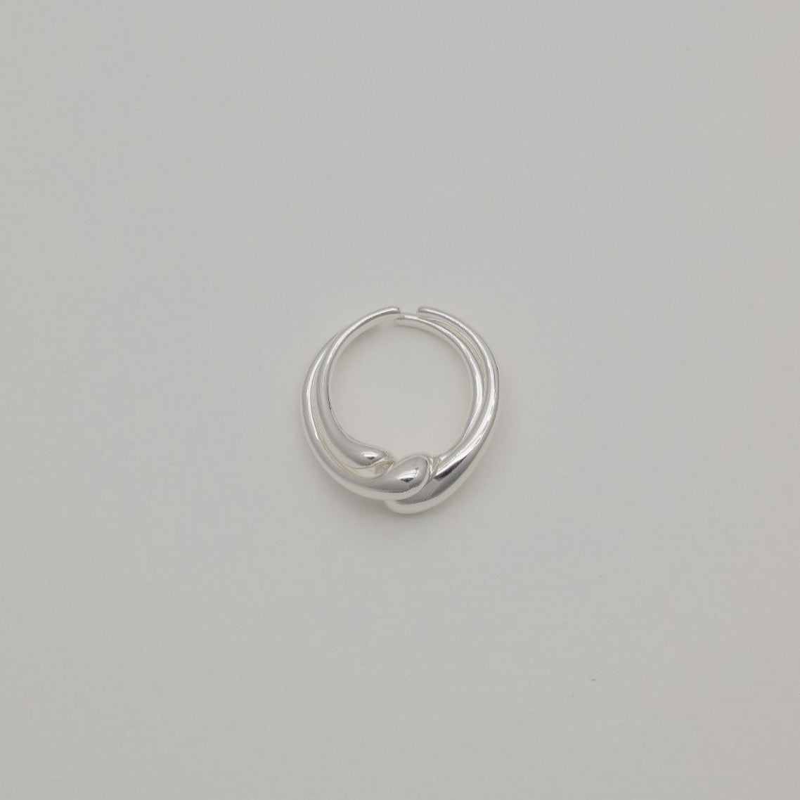 Sterling silver duo rings with soft sculptural curves and open adjustable bands, displayed on a neutral background.