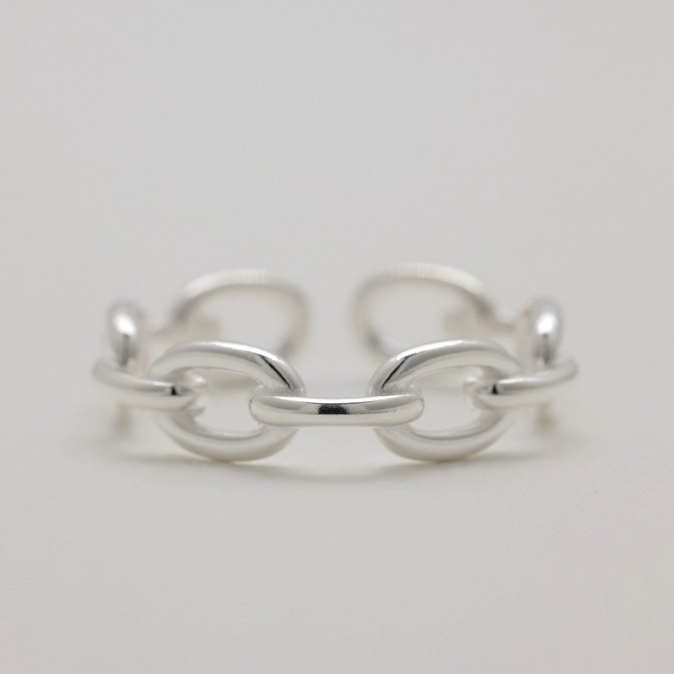 Close-up of the Sylvane Chain Ring showing open back and smooth links