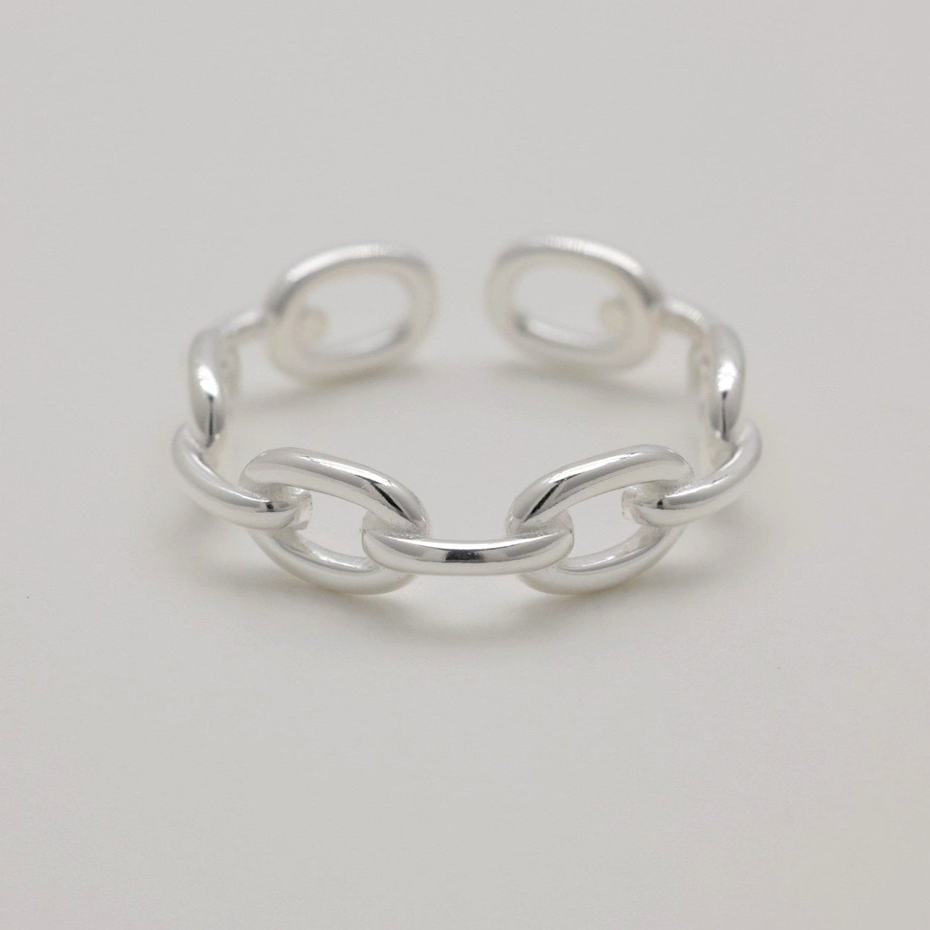Top-down view of sterling silver ring with open chain design