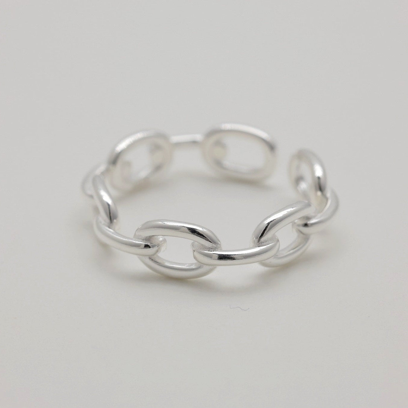 Adjustable chain link ring in polished 925 sterling silver, displayed on white background