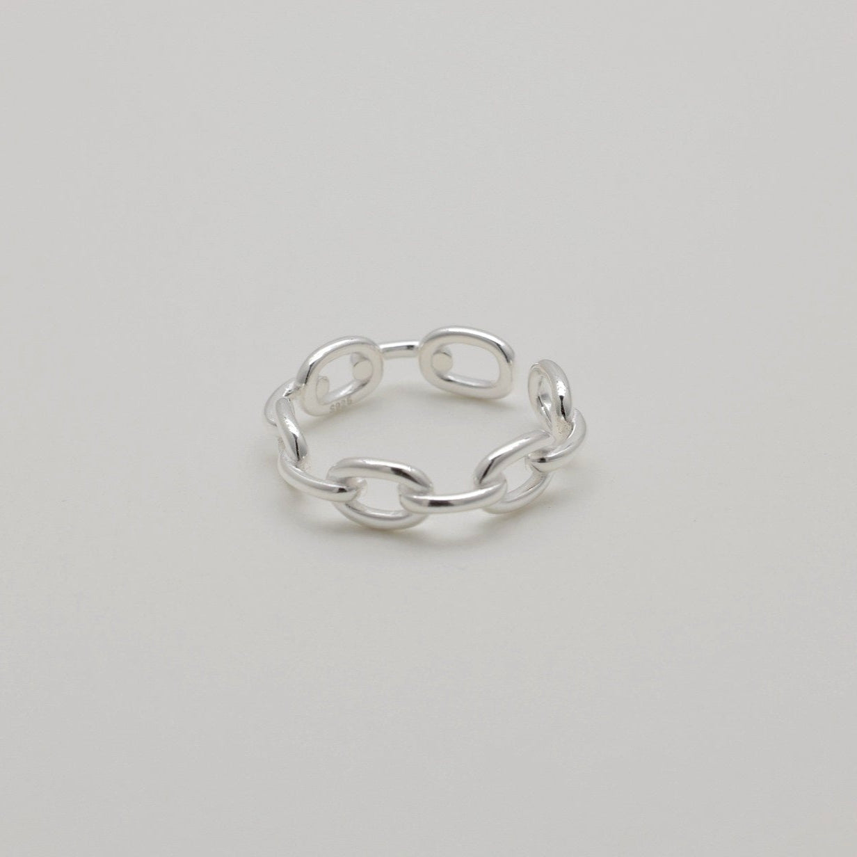 Top-down view of sterling silver ring with open chain design