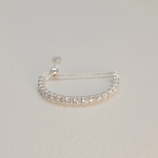 Silver bracelet on a light gray background