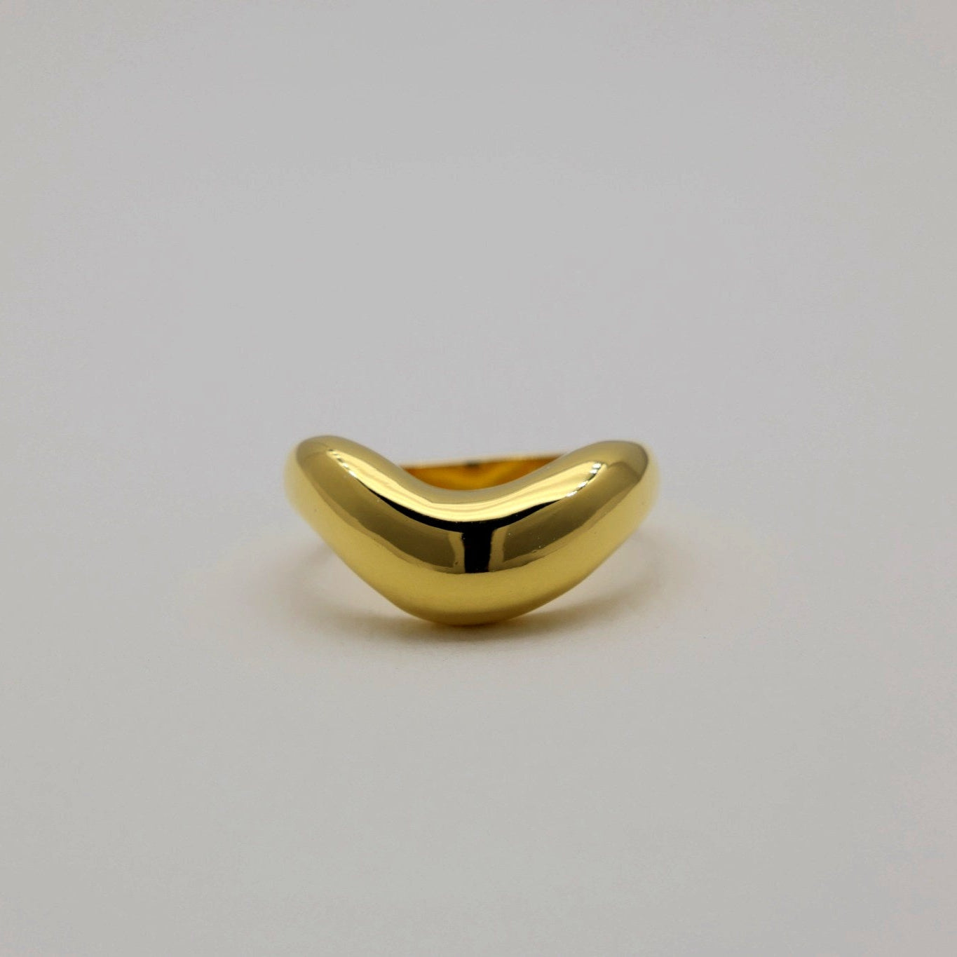 Front view of the high-polish gold vermeil ring with wave-inspired shape.