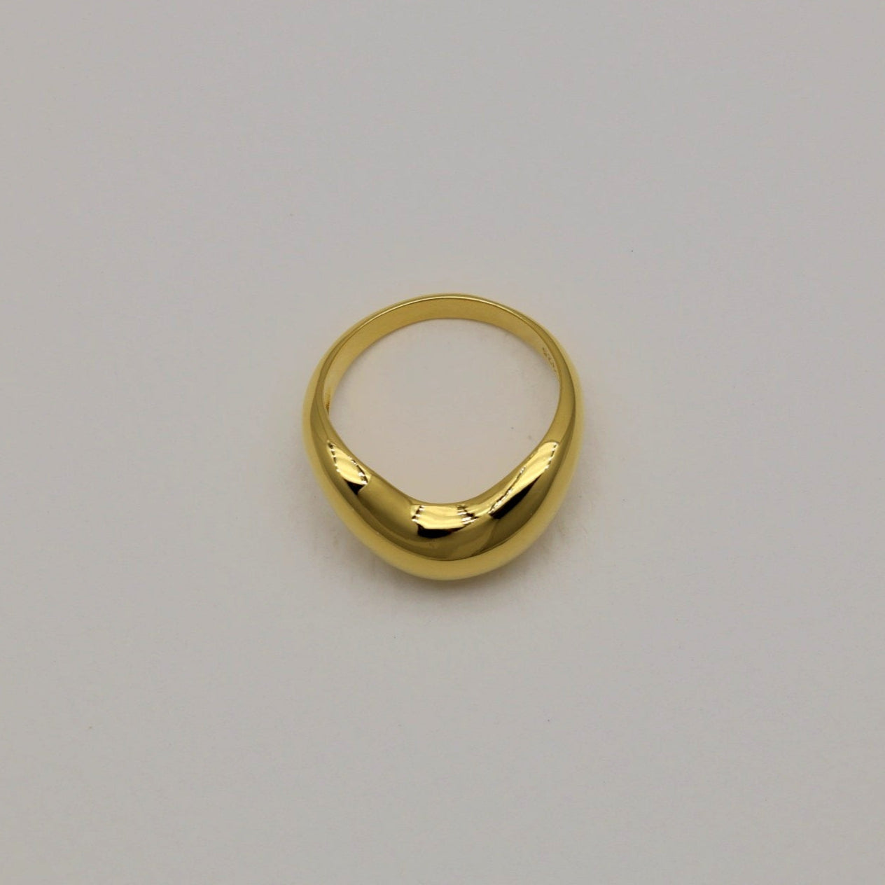Top-down image of the gold vermeil Ondine ring on a soft white background.
