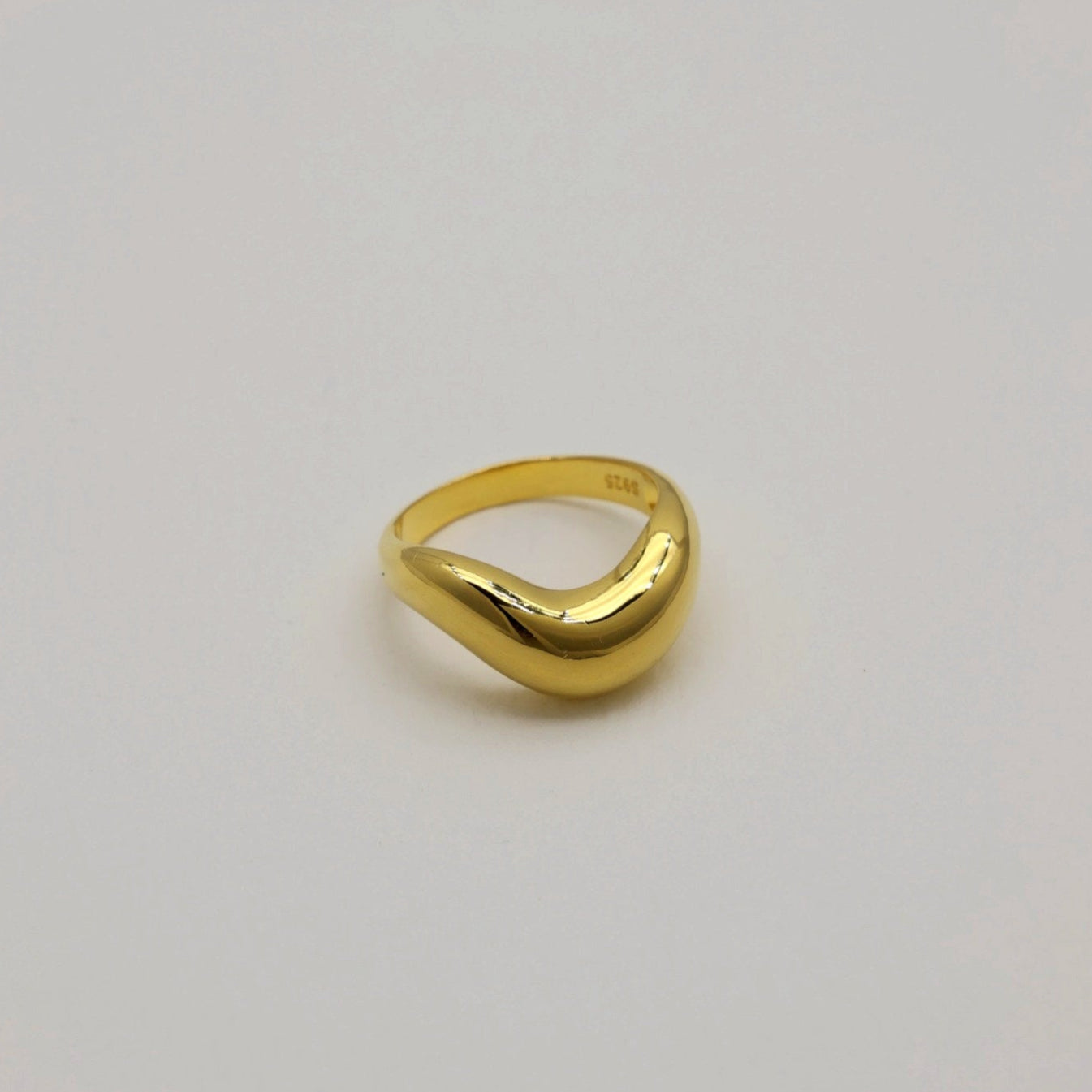 Side angle of the Ondine Sculptural Ring in Gold Vermeil, showing its curved contour.