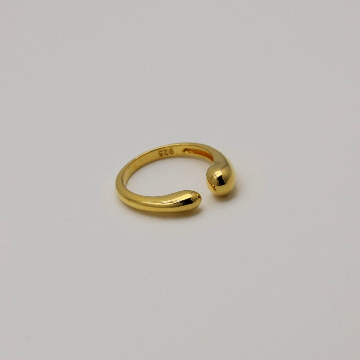 Angled side view of the gold vermeil Delphine ring showing the polished surface and 925 stamp inside the band