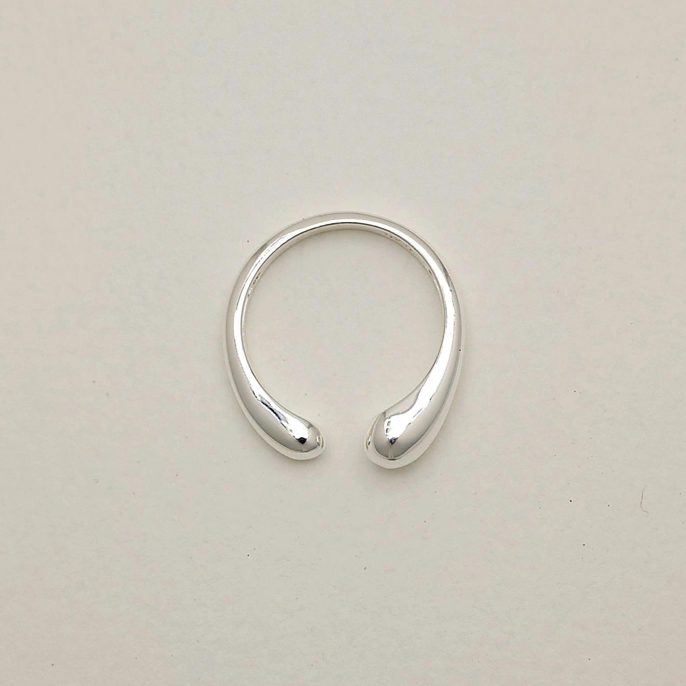 Top-down view of the Delphine Curve Ring showing its open, curved silhouette in polished sterling silver.