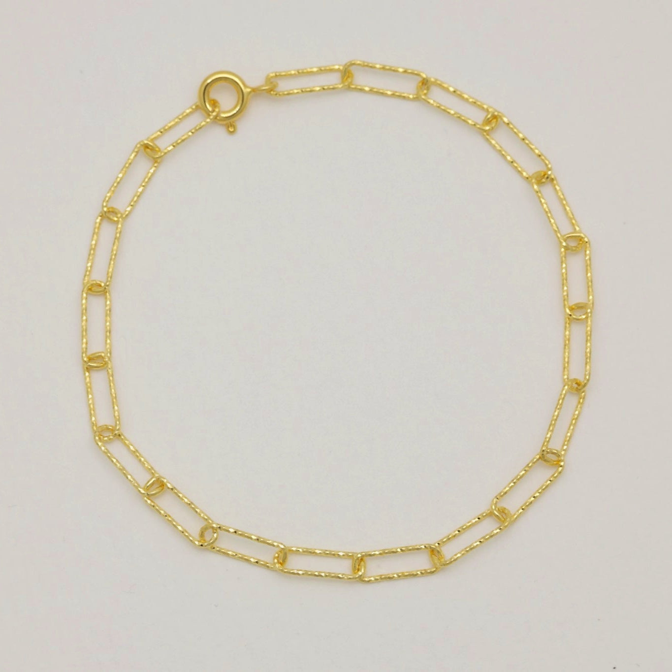 Full bracelet view showing gold vermeil chain in circular shape

