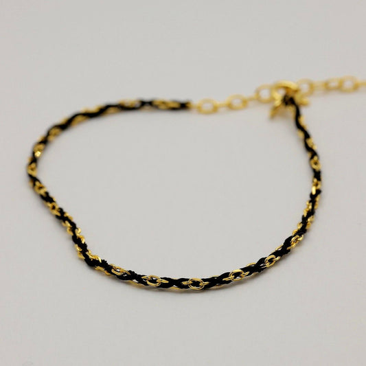 Sabine gold vermeil rope bracelet curved in a semi-circle, showing extender and links.

