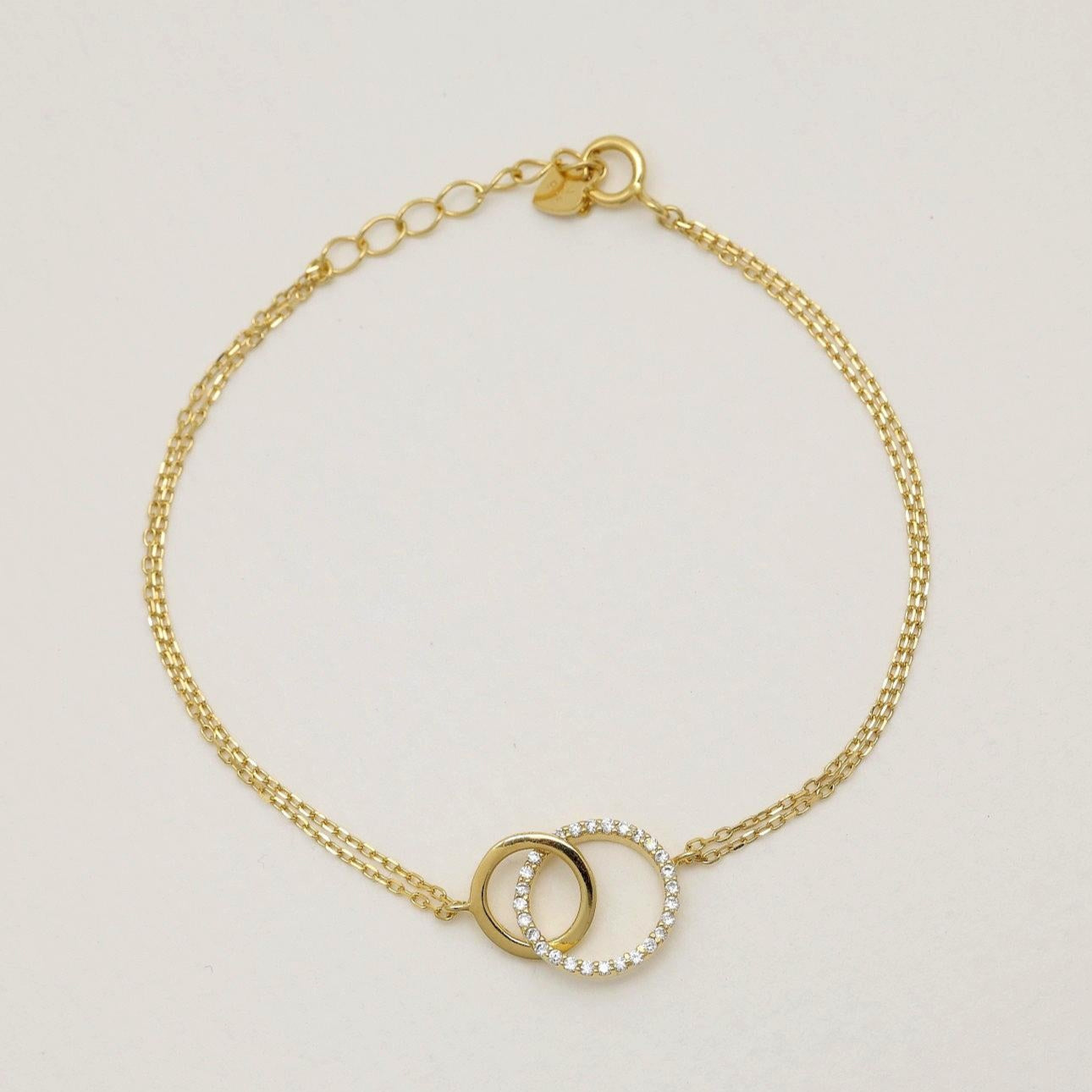 “Gold vermeil bracelet with interlocking circle motif and cubic zirconia”

