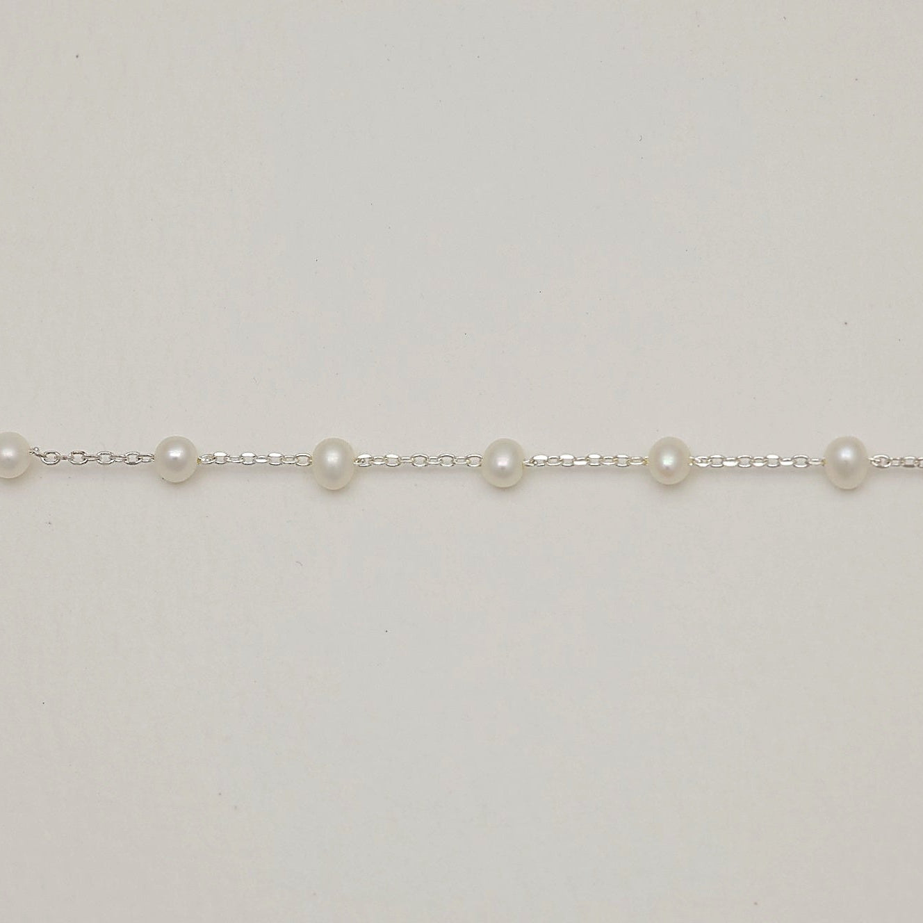 MOA’s delicate Korean-made pearl bracelet on white background

