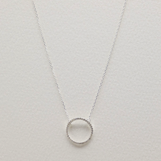Full overhead shot of the necklace laid flat, showing both the pendant and the clasp with extension chain.