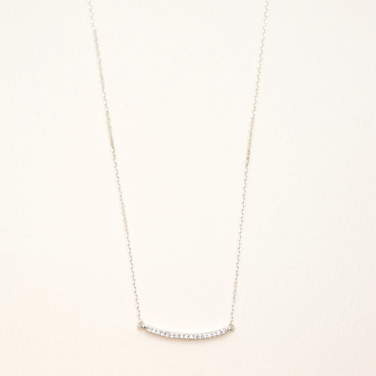 925 sterling silver curved bar necklace with cubic zirconia pavé setting on white background