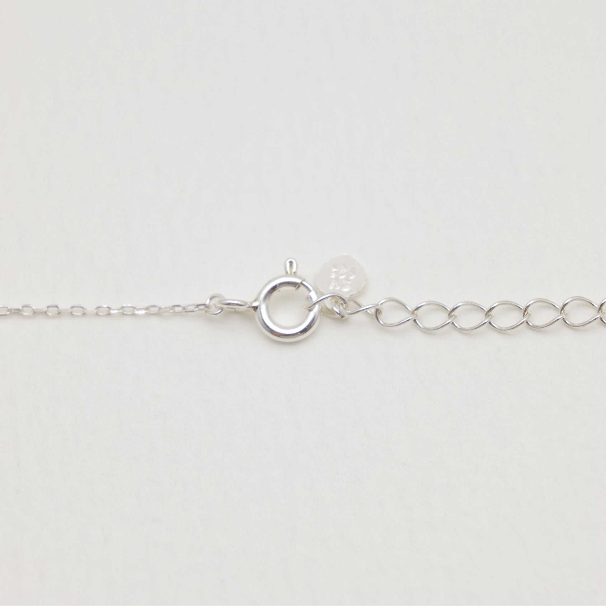 Silver bracelet on a light gray background