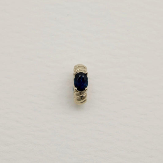 14K white gold charm pendant featuring an oval-cut sapphire with twisted detailing