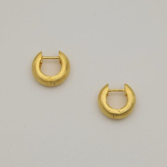 Pair of matte brushed mini gold vermeil hoop earrings on white background.