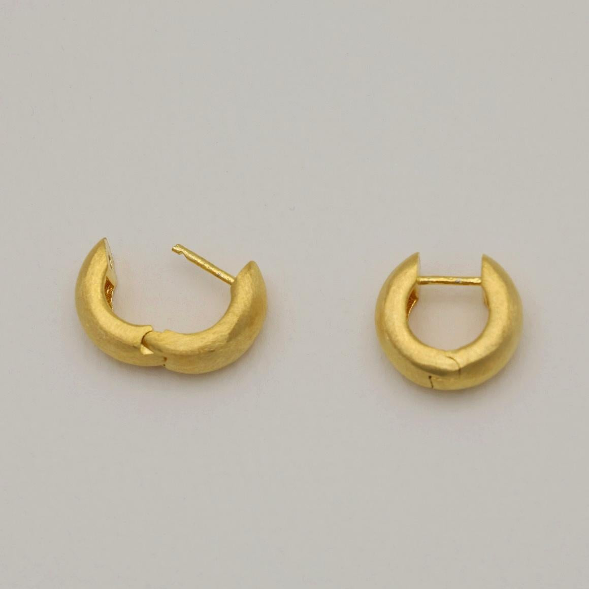 Pair of matte brushed mini gold vermeil hoop earrings on white background.