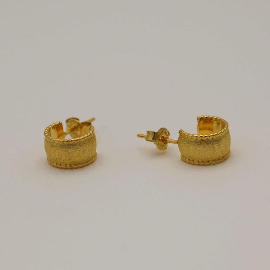 Gold vermeil textured dome huggie earrings with a softly brushed finish, shown from front and side angles on a neutral background.