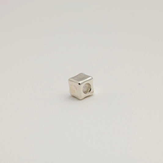 Sculptural cube pendant in polished sterling silver with smooth, contoured edges. Minimal and modern design, made in Korea.