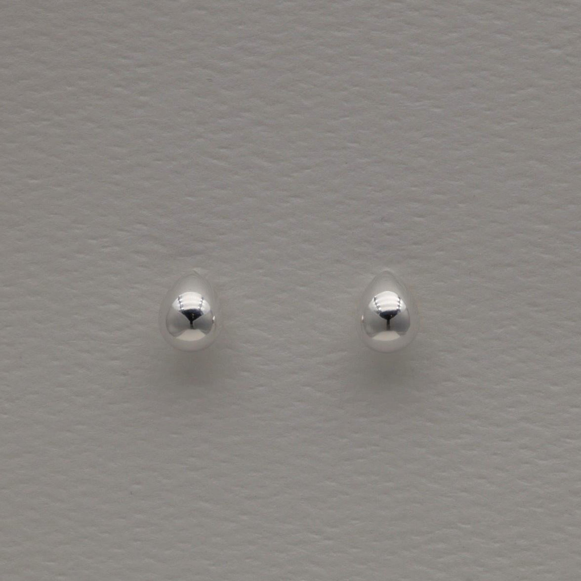Polished sterling silver teardrop-shaped stud earrings with soft rounded edges and butterfly backs