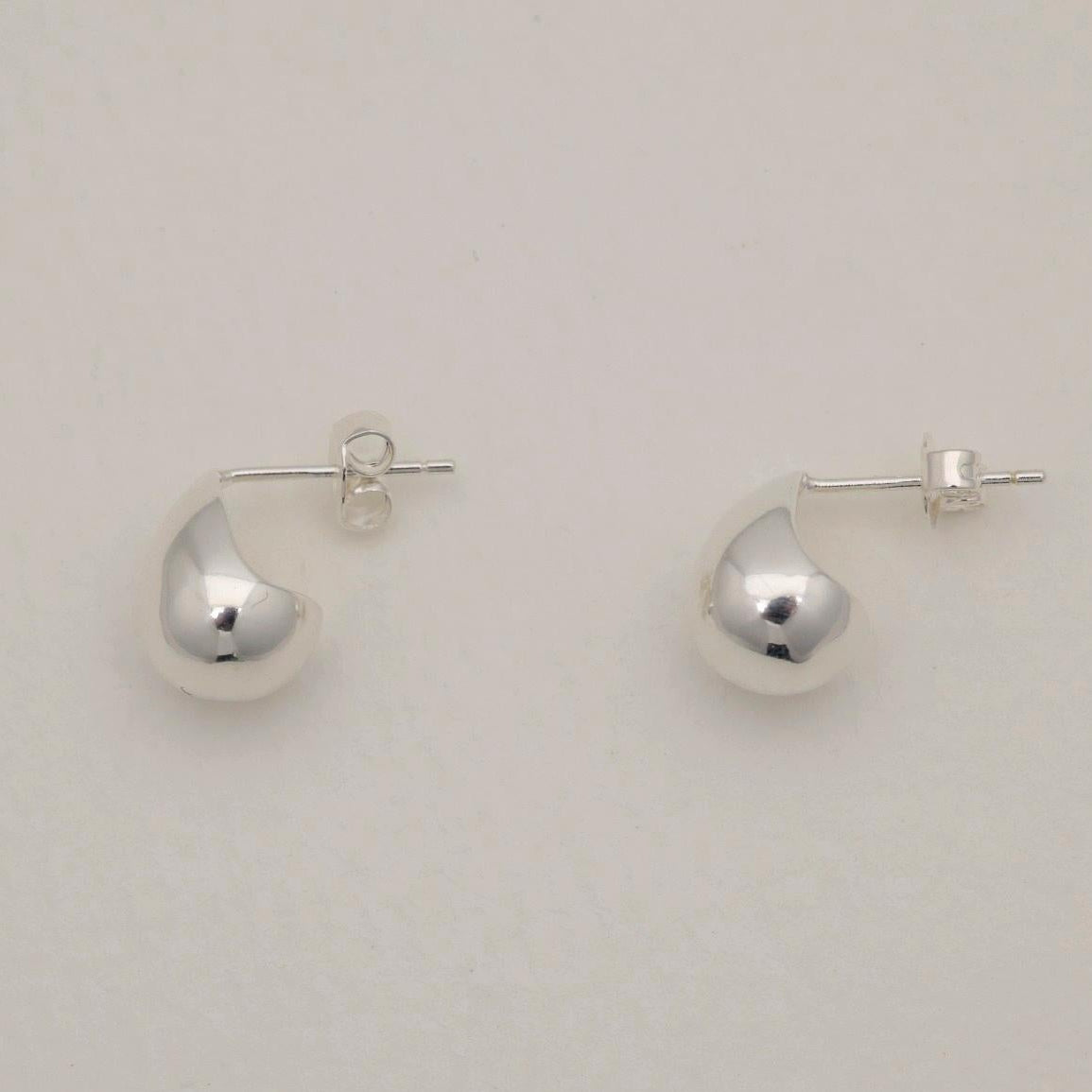 Polished sterling silver teardrop-shaped stud earrings with soft rounded edges and butterfly backs