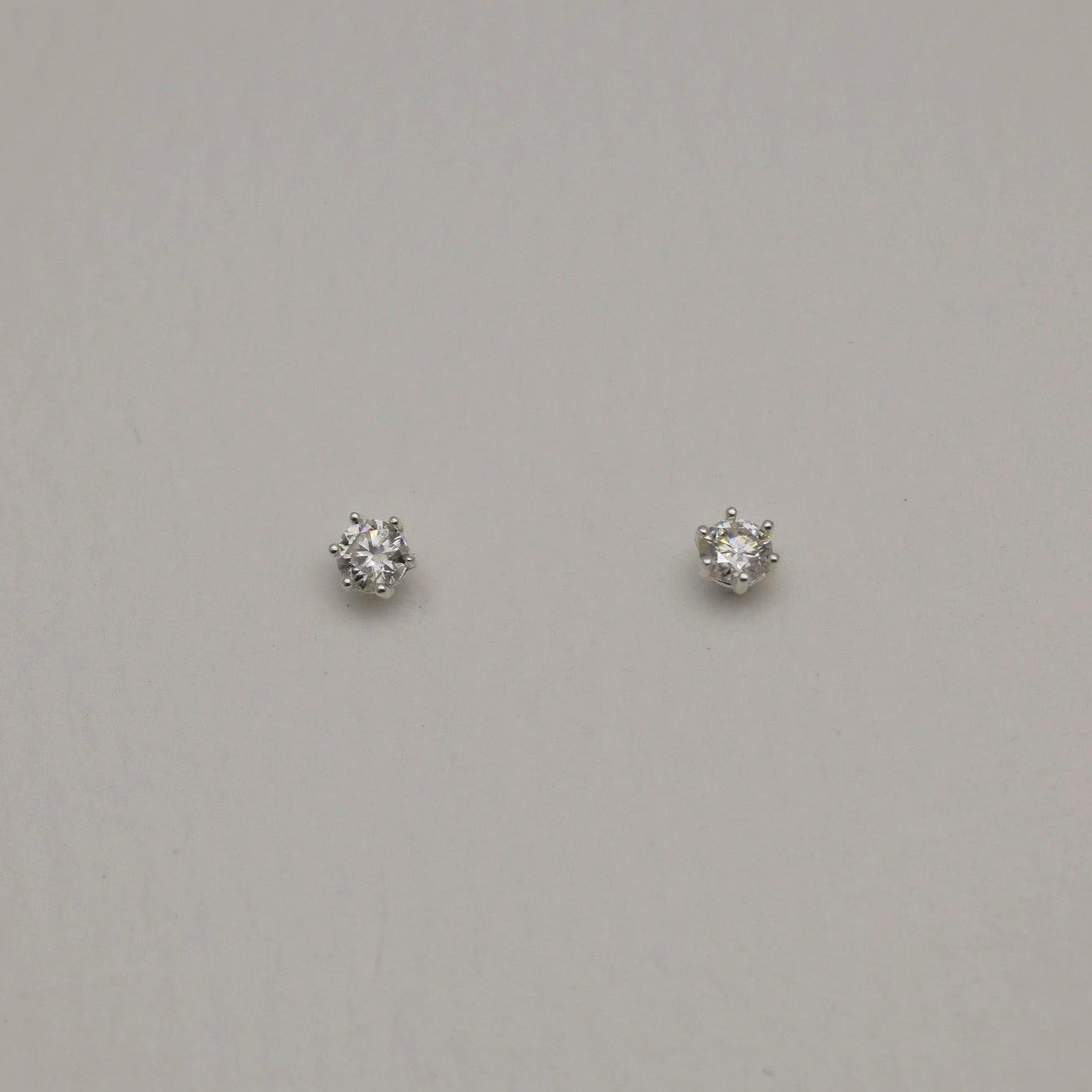 Front and side views of the Loane Moissanite Stud Earrings in Sterling Silver, showing six-prong setting and butterfly backings.