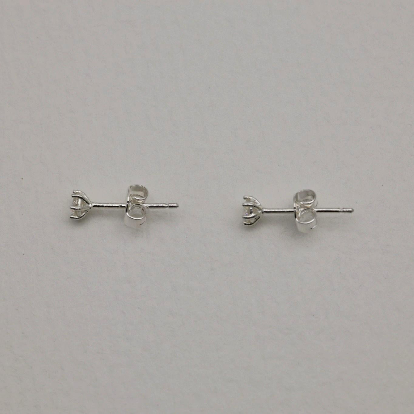 Front and side views of the Loane Moissanite Stud Earrings in Sterling Silver, showing six-prong setting and butterfly backings.