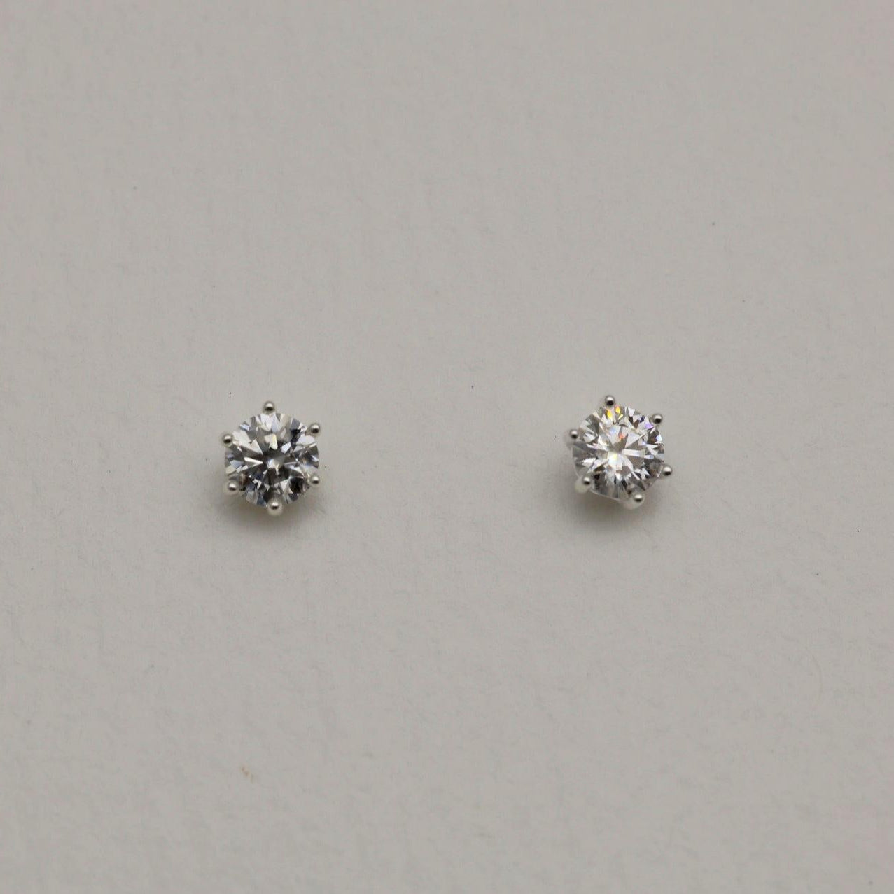 Front and side views of the Loane Moissanite Stud Earrings in Sterling Silver, showing six-prong setting and butterfly backings.