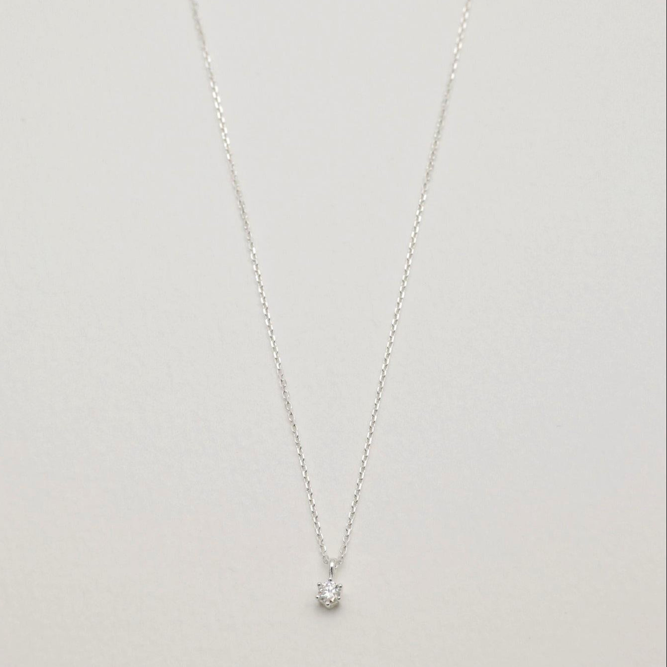Full view of the Lucille Necklace in 925 sterling silver with a round moissanite pendant.

