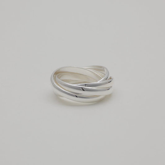 Three interlocking polished sterling silver bands forming a trinity ring

