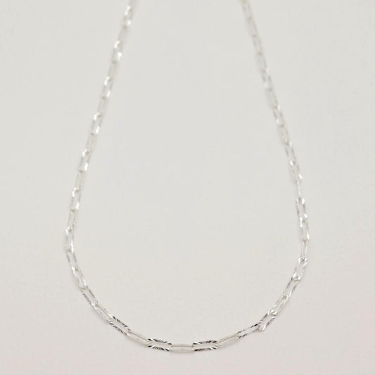 Full view of the Solène Necklace featuring radiant-cut rectangular links on a fine silver chain.