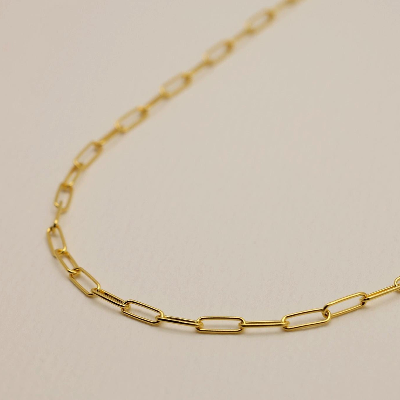 Angled view of gold vermeil chain necklace with elongated links.