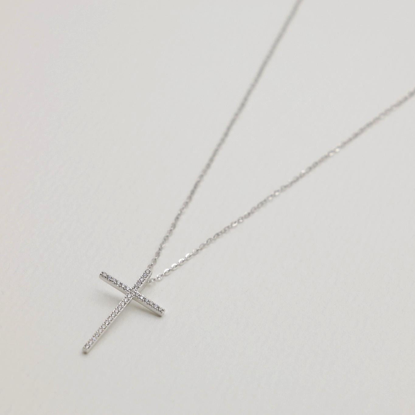 Close-up of the cross pendant with cubic zirconia detailing on the Thérèse Necklace.