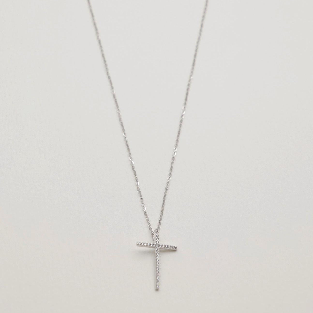Full view of the Thérèse Necklace featuring a CZ-studded cross pendant on a 925 sterling silver chain.