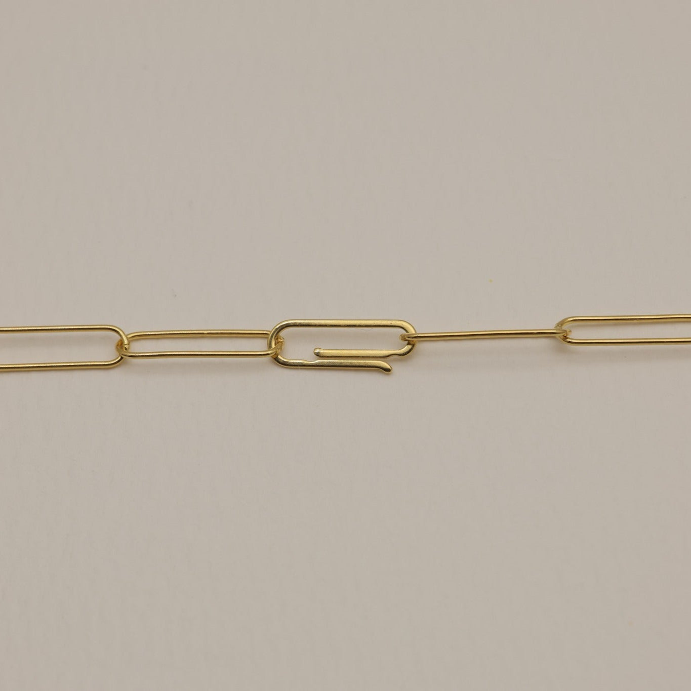 A macro image of the necklace’s clasp and chain links, emphasizing the hook closure and polished finish.