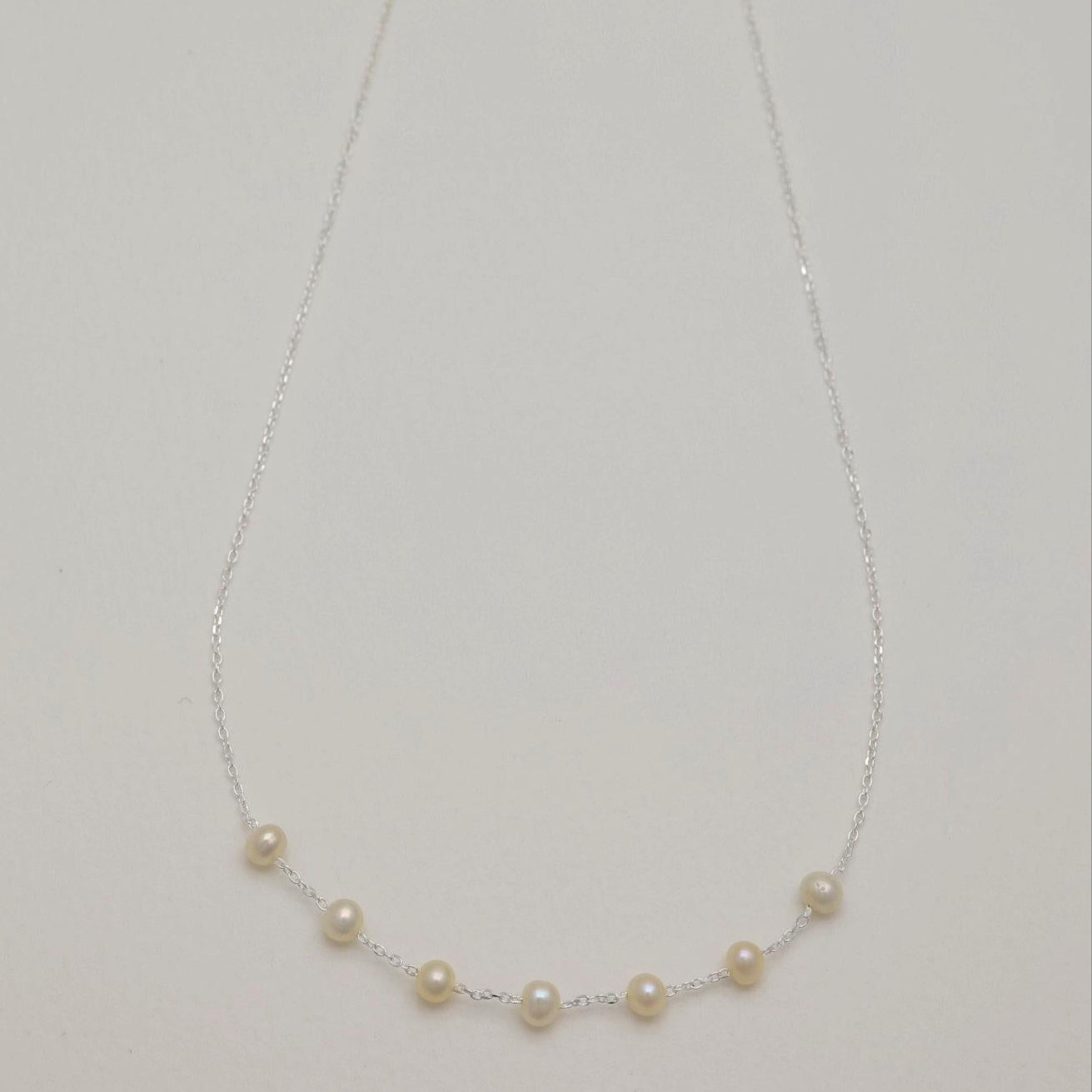 Full view of the Vivienne Necklace in 925 sterling silver, featuring natural pearls on a delicate chain.