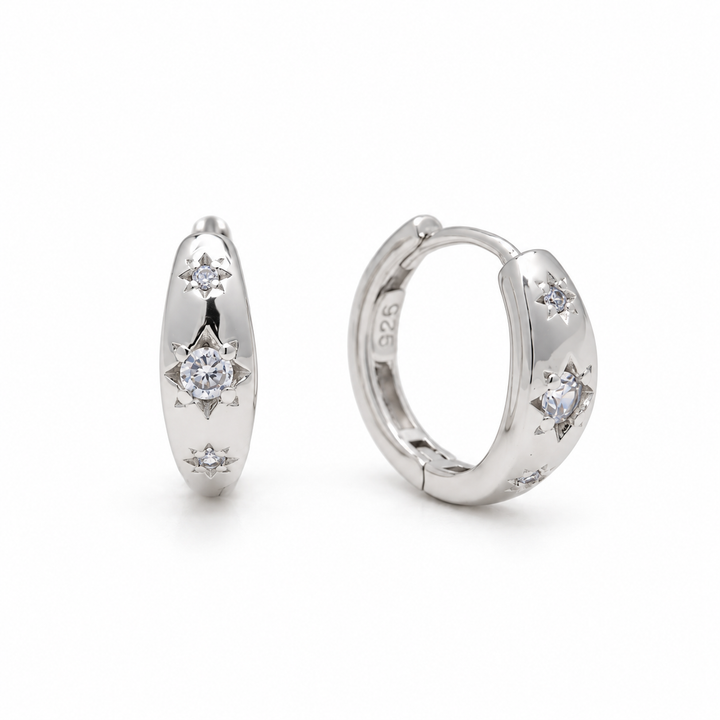 Lucie Star-Set Huggie Earrings in 925 sterling silver, one pair on white background