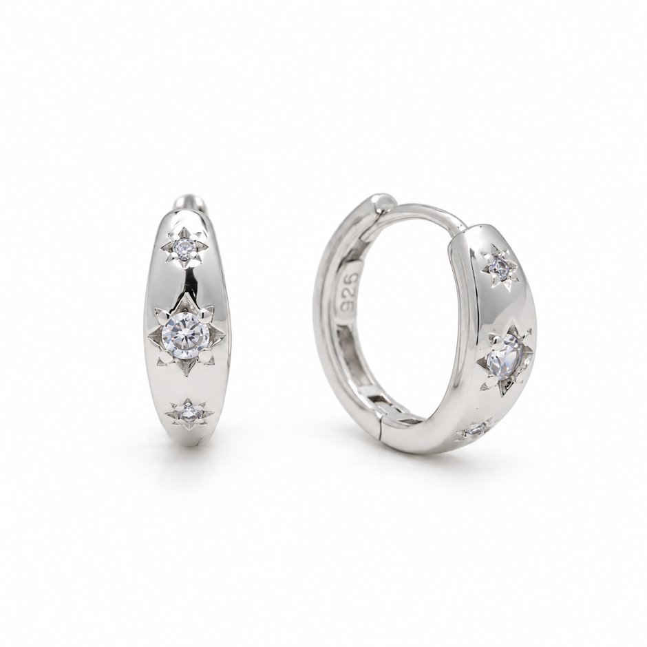 Lucie Star-Set Huggie Earrings in 925 sterling silver, one pair on white background