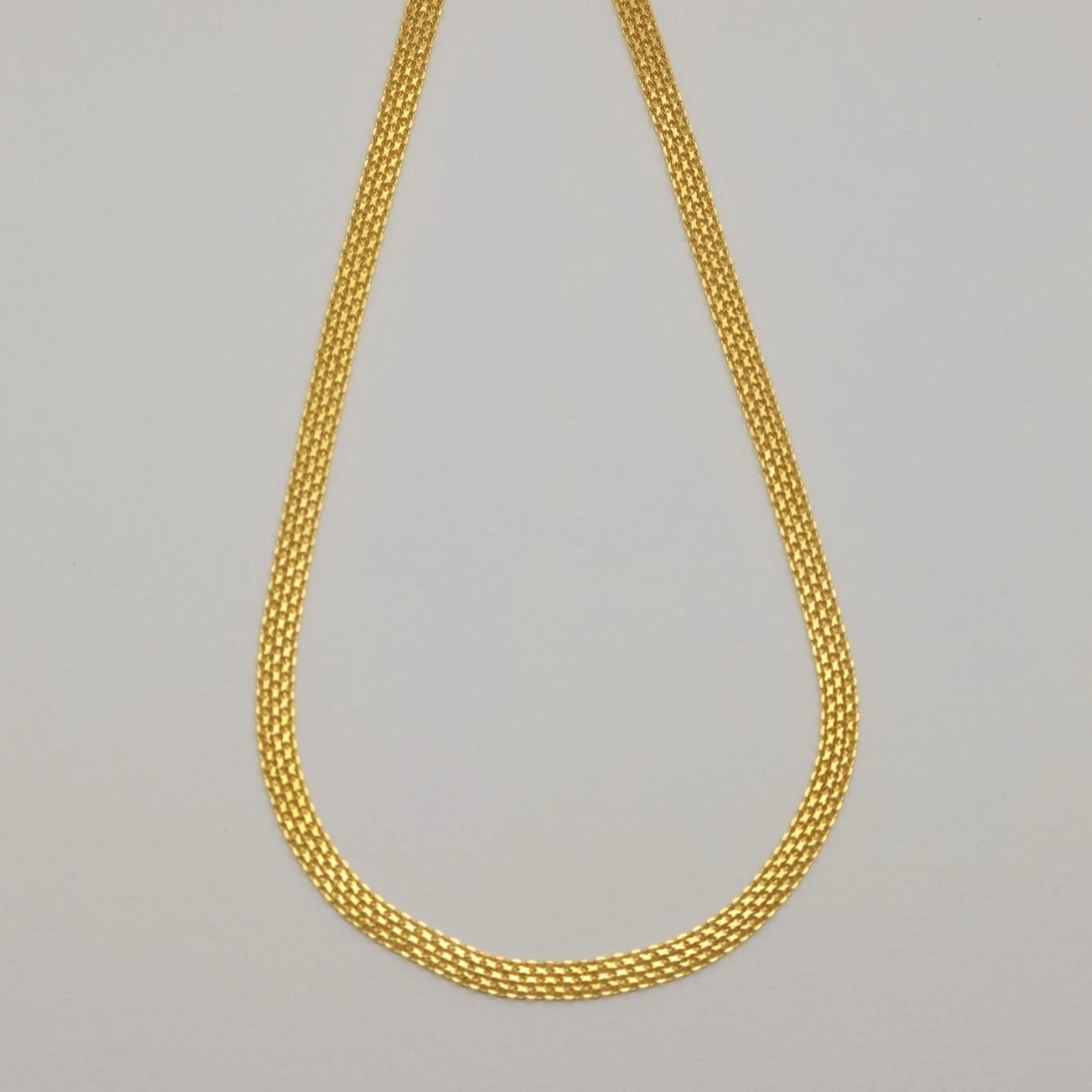Gold vermeil mesh necklace laid flat showing intricate woven links.