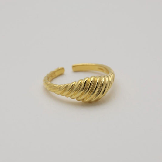 Side angle of the Odile Ring, highlighting its wave-like texture and polished finish.


