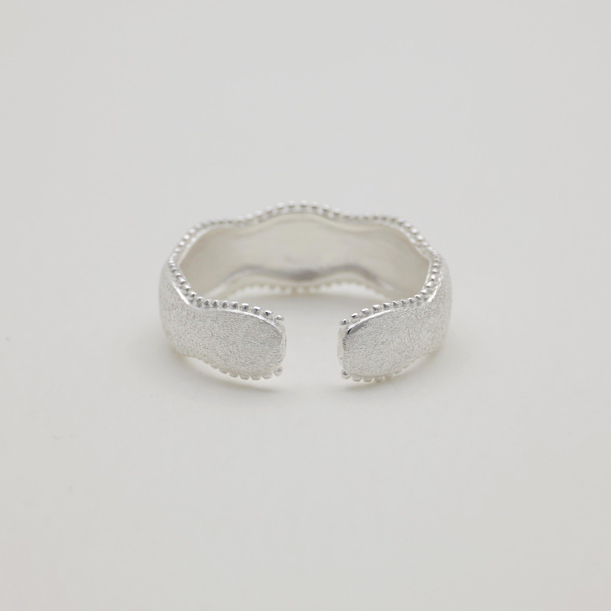 Styled ring shot with soft shadow and natural light

