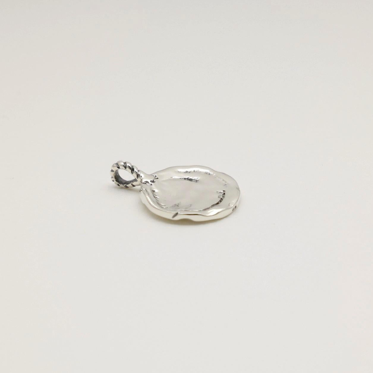 Silver pendant on a white background